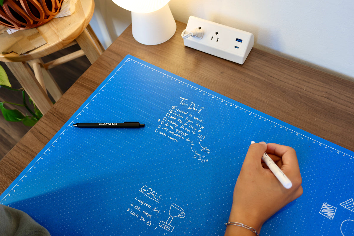 Writing a to-do list in white marker on the blue Linework Mat