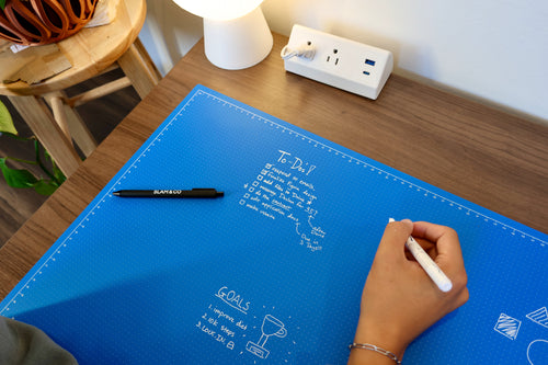 Writing a to-do list in white marker on the blue Linework Mat